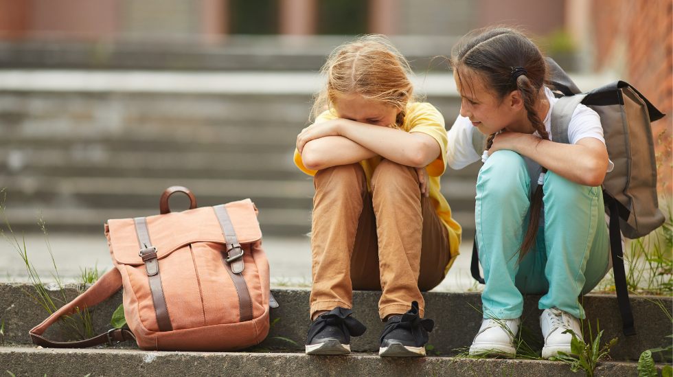 girl comforting her bullied friend